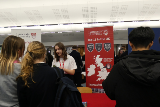 Pupils talk to a representative from Lancaster University at the Careers Fair.