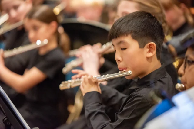 Pupils playing the flute in a concert.