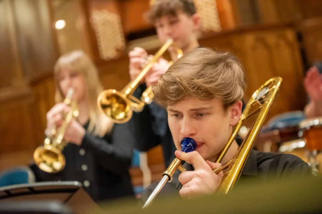 Pupils playing the trumpet in a school music concert.