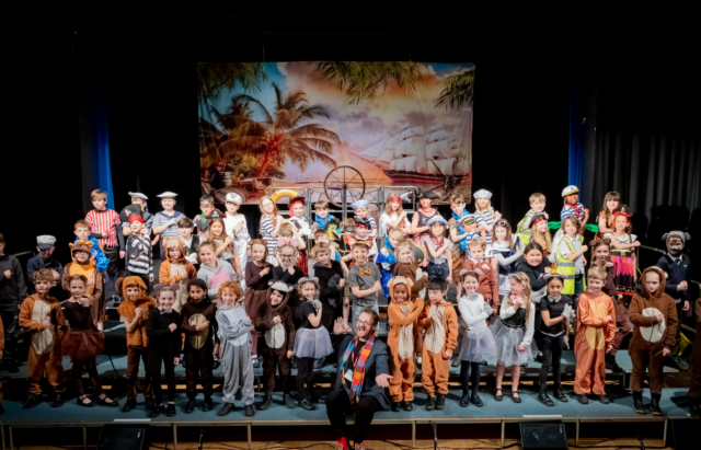 A large group of Year 3 and Year 4 pupils after performing their show.