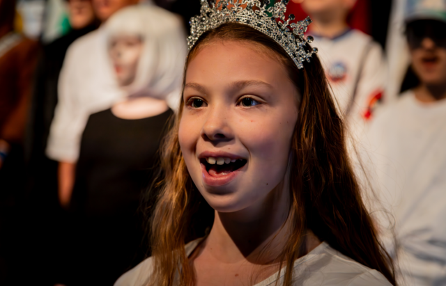 A female pupil confidently speaking during a show.